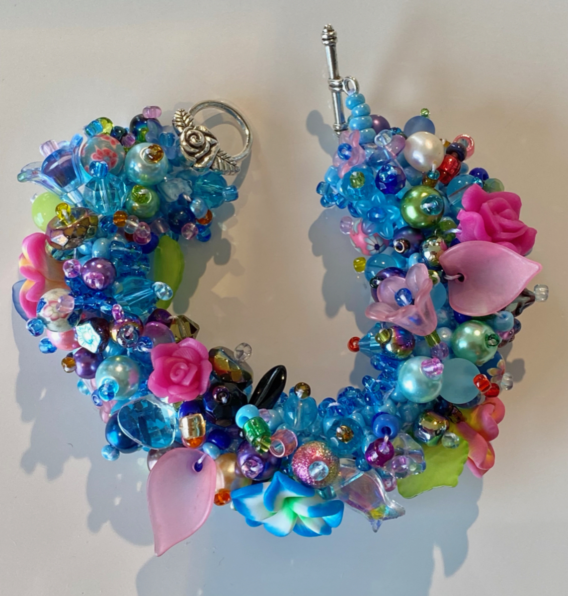 Bracelet - wide - multi coloured blue with pink flowers