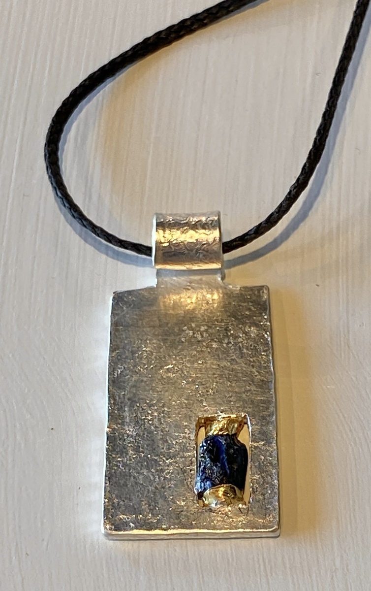 Sterling silver pendant with 22ct gold and rough sapphire